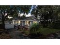 Exterior view of a charming home with a covered porch, landscaping, and a beautiful yard at 212 W Powhatan Ave, Tampa, FL 33604
