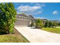 Charming home with a two-car garage and lush landscaping, offering great curb appeal at 2247 Midnight Pearl Dr, Sarasota, FL 34240