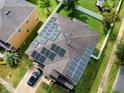 Aerial view of a home with solar panels installed on the roof, showcasing a green energy solution and modern design at 2325 Via Bella Blvd, Land O Lakes, FL 34639