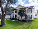 Charming two-story home featuring a two-car garage, well-manicured lawn, and elegant architectural details at 2619 Green Valley St, Valrico, FL 33596