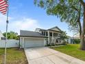 Charming two-story home featuring a two-car garage, well-manicured lawn, and elegant architectural details at 2619 Green Valley St, Valrico, FL 33596