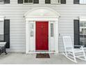 Up close image of the Front Door with a red painted door and white trim at 2619 Green Valley St, Valrico, FL 33596