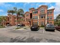 Attractive condo building with convenient parking and lush palm trees, offering a desirable residential experience at 2705 Via Murano # 127, Clearwater, FL 33764