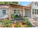 Inviting front porch featuring wood columns, comfortable seating, and lush greenery at 2911 N Jefferson St, Tampa, FL 33602