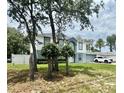 Inviting two-story home featuring an attached two car garage and manicured yard at 3181 Deltona Blvd, Spring Hill, FL 34606