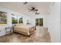Spacious bedroom with natural light, ceiling fans, and access to a patio through sliding glass doors at 3321 14Th N St, St Petersburg, FL 33704