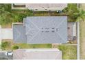 Aerial view of roof featuring architectural shingles, gutters and a screened in patio at 3351 Lintower Dr, Land O Lakes, FL 34638
