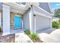 Inviting front entrance with a vibrant blue door, stone accents, and a welcoming walkway at 3602 W Iowa Ave, Tampa, FL 33611