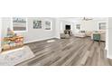 Bright and airy living room with wood floors and ample natural light from the many windows at 3602 W Iowa Ave, Tampa, FL 33611