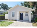 Charming single-story home with a freshly painted exterior, walkway, and neat landscaping at 3615 W Cherry St, Tampa, FL 33607