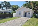 Inviting single-story home with a paved driveway and a manicured green lawn at 3615 W Cherry St, Tampa, FL 33607