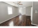 Inviting living room featuring sleek hardwood floors and ample natural light from large windows at 3615 W Cherry St, Tampa, FL 33607
