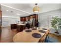 Open-concept kitchen and dining area featuring stainless steel appliances, central island, and large dining table set for eight at 4208 W Bay Vista Ave, Tampa, FL 33611