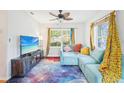 Bright living room with unique galaxy carpet, a comfortable blue sofa and lots of natural light at 4801 71St N St, St Petersburg, FL 33709