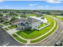 Rear exterior of home backing up to the lake, surrounded by a white fence at 4805 Holdsworth Dr, Land O Lakes, FL 34639