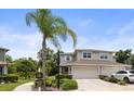 Charming home featuring a two-car garage, beautiful landscaping, a well-manicured lawn, and a welcoming front entrance at 5332 Riverwalk Preserve Dr, New Port Richey, FL 34653