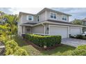 Charming two-story home boasts a well-manicured lawn, tasteful landscaping, and a convenient two-car garage at 5332 Riverwalk Preserve Dr, New Port Richey, FL 34653