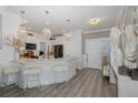 Bright kitchen features elegant chandeliers, a stylish island with seating, and modern appliances at 5332 Riverwalk Preserve Dr, New Port Richey, FL 34653