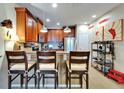 Cozy kitchen features wooden cabinetry, a breakfast bar with seating, and stainless steel appliances at 5646 Sunset Falls Dr, Apollo Beach, FL 33572
