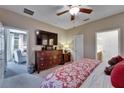 Comfortable main bedroom with a ceiling fan, ensuite bathroom, and views into the living area at 5646 Sunset Falls Dr, Apollo Beach, FL 33572