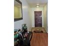 Inviting entryway with wood-look flooring, decor and a mirror at 603 Southwood Cv, Brandon, FL 33511