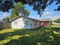 Side view of a charming brick home showing mature landscaping at 603 Southwood Cv, Brandon, FL 33511