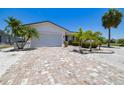 Charming home with a large, brick-paved driveway and well-manicured tropical landscaping at 6322 Cocoa Ln, Apollo Beach, FL 33572