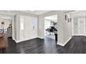 Bright foyer features dark floors, a glass front door, and seamless transition to the office and dining area at 7092 119Th St, Seminole, FL 33772