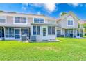 The backyard featuring a well-manicured lawn and screened patio for relaxing or entertaining guests at 727 Kensington Lake Cir, Brandon, FL 33511
