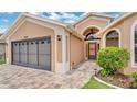 Charming single-story home featuring a brick driveway, well-manicured lawn, and an attached two-car garage at 9735 Conservation Dr, New Port Richey, FL 34655