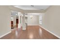 Spacious living room with hardwood floors, decorative columns, and a chandelier at 9735 Conservation Dr, New Port Richey, FL 34655