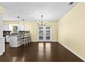 Open dining area with wood floors and backyard views from the French doors at 9780 Allen Rd, Lithia, FL 33547