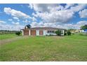 Inviting single story home with a well-manicured lawn and a two-car garage at 9780 Allen Rd, Lithia, FL 33547