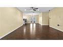 Open-concept living room with hardwood floors, ceiling fan, and views of the backyard at 9780 Allen Rd, Lithia, FL 33547