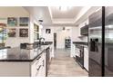 Modern kitchen features sleek granite countertops, stainless steel appliances, and wood-look flooring at 3254 Great Neck St, Port Charlotte, FL 33952