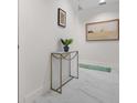 Bright hallway with marble floors, decorative console table, and stylish artwork, enhancing the interior aesthetic at 1010 Central Ave # 227, St Petersburg, FL 33705