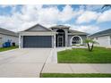 Charming single Gathering home with a two-car garage, front yard, and well-maintained landscaping at 10811 Lakeside Vista Dr, Riverview, FL 33569
