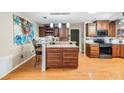 A kitchen featuring granite countertops, dark wood cabinets, and stainless steel appliances at 10954 96Th St, Largo, FL 33773