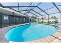 Beautiful private pool with a screened enclosure and a brick surround at 10954 96Th St, Largo, FL 33773