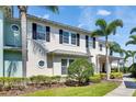 Beautifully landscaped side view highlighting the architectural details of this light and airy home with palm trees and fresh landscaping at 110 Aberdeen Pond Dr, Apollo Beach, FL 33572