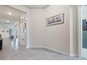 Elegant hallway showcasing neutral walls, ceramic tile flooring and sophisticated decor at 12401 Shining Willow St, Riverview, FL 33579