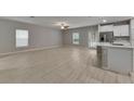 Open concept living room and kitchen with tile floors and ample natural light at 12617 Maple Bonsai Dr, Riverview, FL 33579