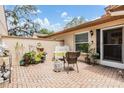 Cozy patio space with brick flooring and comfortable seating arrangement at 13205 Cypress Hill Dr, Hudson, FL 34669