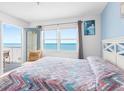 Inviting bedroom with ocean views and access to a private balcony at 13500 Gulf Blvd # 706, Madeira Beach, FL 33708