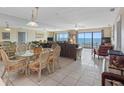 Bright and airy living room with tile floors, ocean views, and comfortable seating at 13500 Gulf Blvd # 706, Madeira Beach, FL 33708