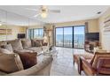 Spacious living room with tile floors, ocean views, and plenty of natural light at 13500 Gulf Blvd # 706, Madeira Beach, FL 33708