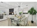 Open-concept dining room with designer light fixture and view of fireplace and kitchen at 14170 Fennsbury Dr, Tampa, FL 33624