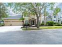 Charming two-story home featuring a three-car garage and meticulously landscaped front yard at 16170 Colchester Palms Dr, Tampa, FL 33647