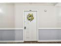 Condo door with welcoming floral wreath at 17920 Gulf Blvd # 208, Redington Shores, FL 33708