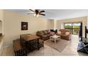 Living room featuring a ceiling fan, fireplace, comfortable seating, and sliding glass doors at 1905 Oyster Catcher Ln # 924, Clearwater, FL 33762